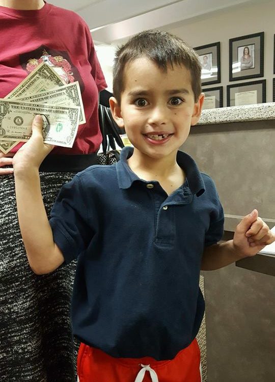 A child participating in Operation Gratitude Candy Buy Back at Lydiatt and Duru Family Dentistry.