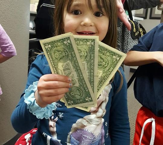 A child participating in Operation Gratitude Candy Buy Back at Lydiatt and Duru Family Dentistry.