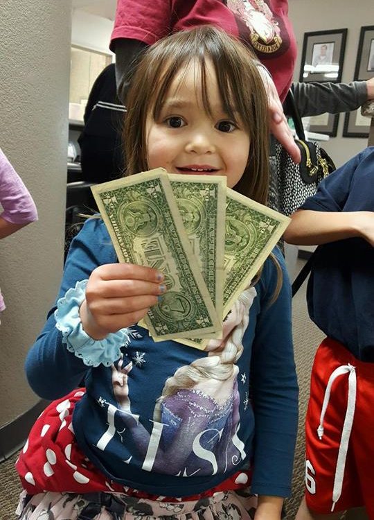 A child participating in Operation Gratitude Candy Buy Back at Lydiatt and Duru Family Dentistry.