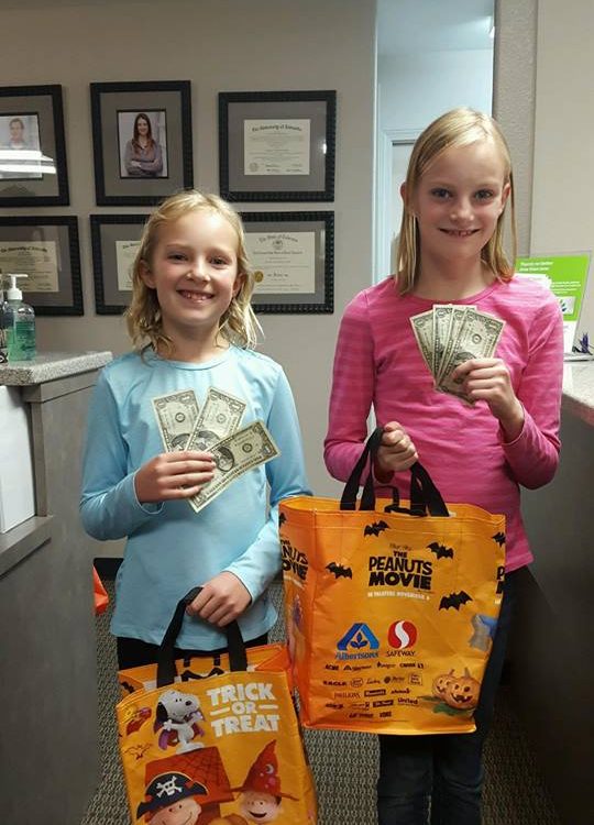 Two children participating in Operation Gratitude Candy Buy Back at Lydiatt and Duru Family Dentistry.